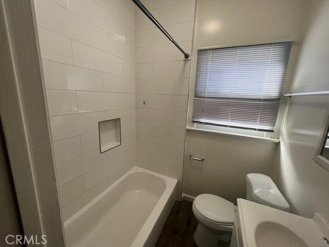 full bath with toilet, bathtub / shower combination, and a sink