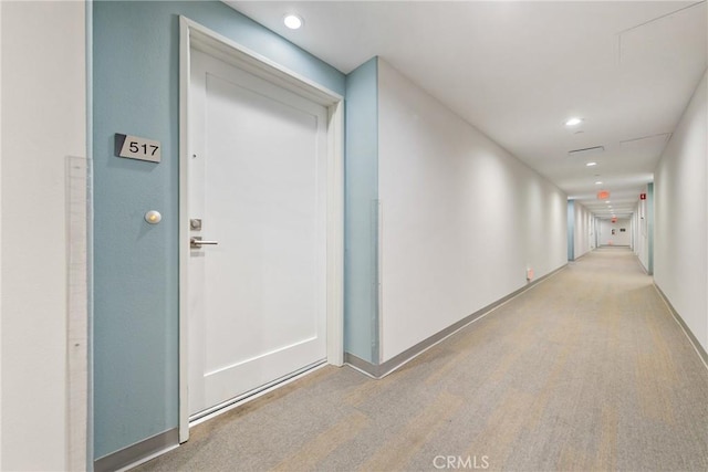 corridor featuring baseboards and recessed lighting