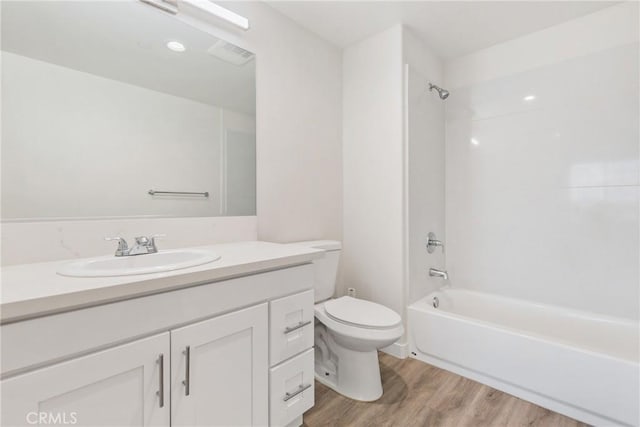 full bathroom featuring vanity, tub / shower combination, wood finished floors, and toilet