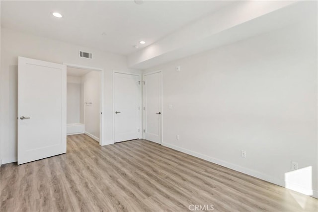 unfurnished bedroom with recessed lighting, baseboards, visible vents, and light wood finished floors