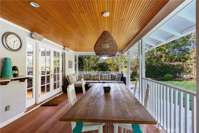 unfurnished sunroom featuring wood ceiling and french doors