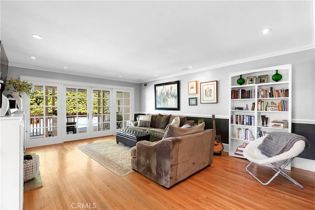 living area with crown molding, recessed lighting, french doors, and wood finished floors
