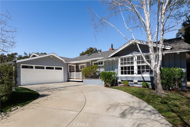 single story home with concrete driveway, board and batten siding, and an attached garage