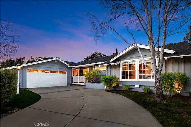 ranch-style home with an attached garage, board and batten siding, and driveway