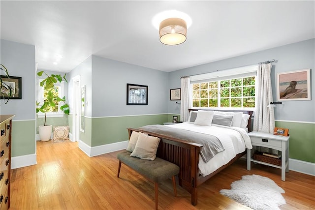 bedroom with light wood-style flooring and baseboards