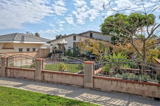 view of front of property featuring a fenced front yard and stucco siding