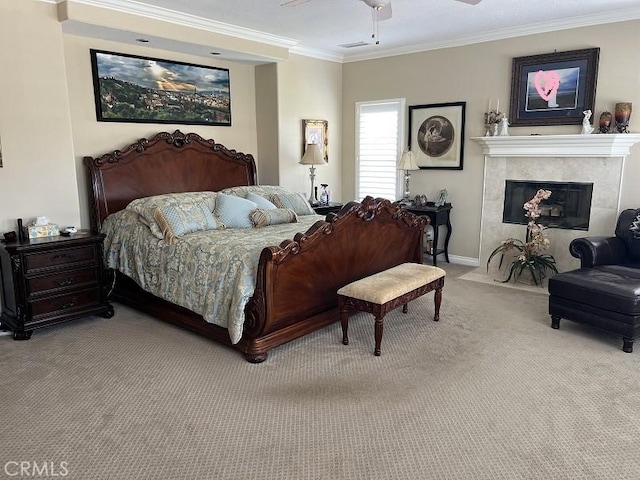 bedroom featuring baseboards, ceiling fan, crown molding, carpet floors, and a fireplace