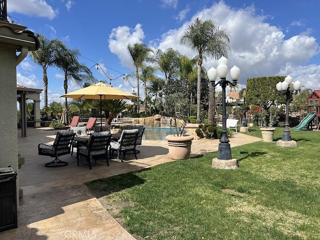 view of home's community with a pool, a patio area, playground community, and a lawn