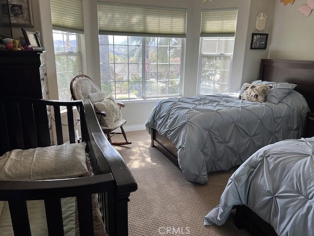 bedroom featuring carpet and baseboards