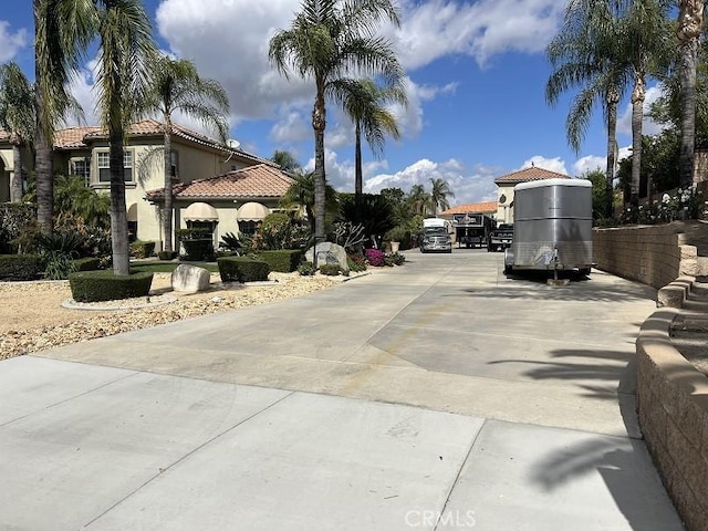 view of street featuring concrete driveway