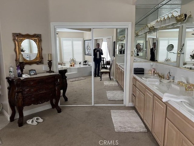 bathroom featuring vanity and a bath