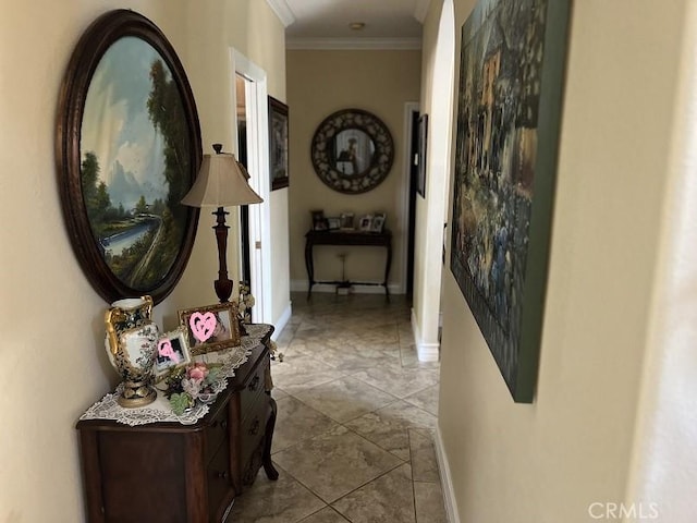 corridor with ornamental molding and baseboards