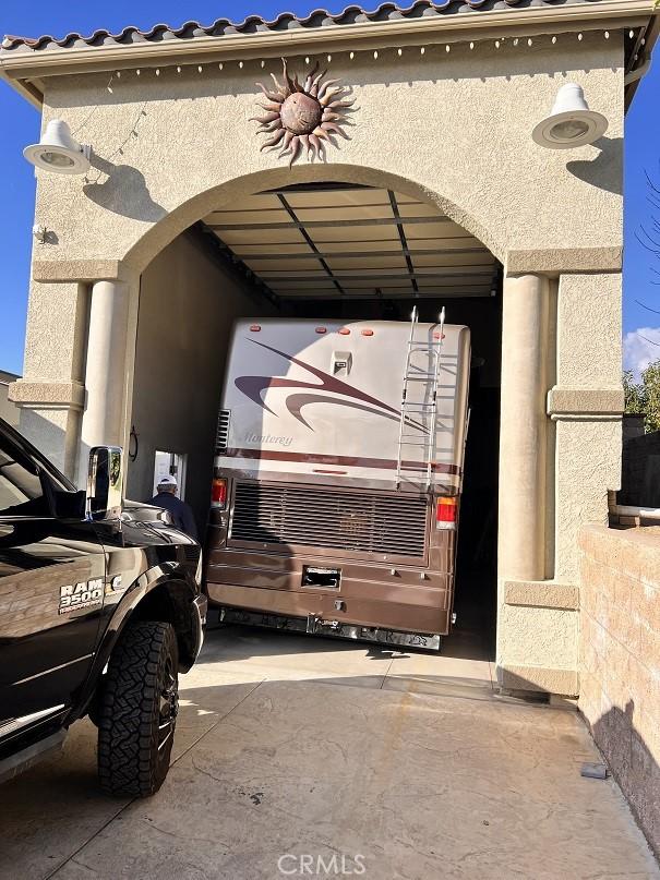 view of vehicle parking with a carport and driveway