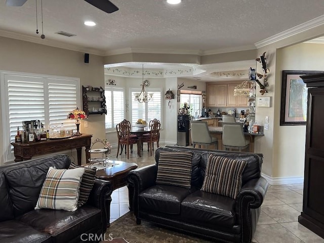 living area with a textured ceiling, visible vents, crown molding, and light tile patterned flooring