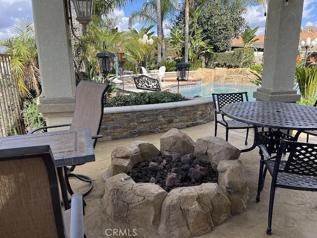 view of patio / terrace with outdoor dining area and an outdoor pool