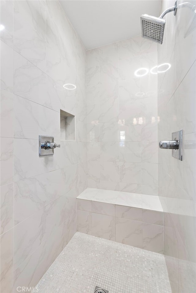 full bath featuring a tile shower