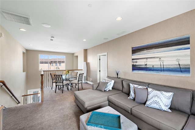 living area with carpet floors, visible vents, and recessed lighting