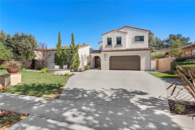 mediterranean / spanish-style home with an attached garage, fence, concrete driveway, a tiled roof, and stucco siding