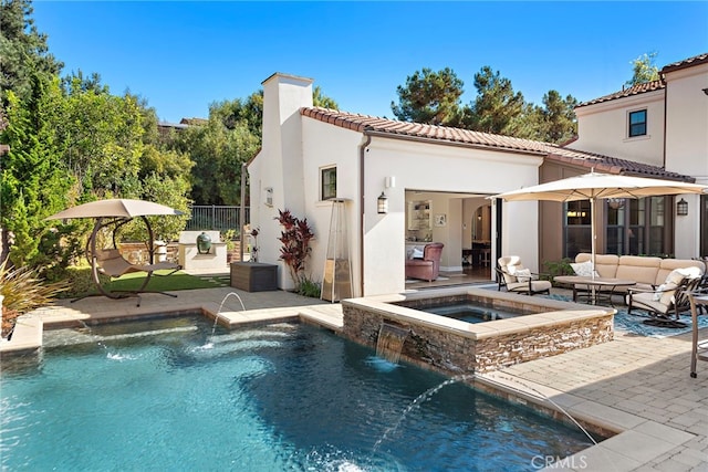 back of property with an in ground hot tub, a patio area, an outdoor living space, and an outdoor pool