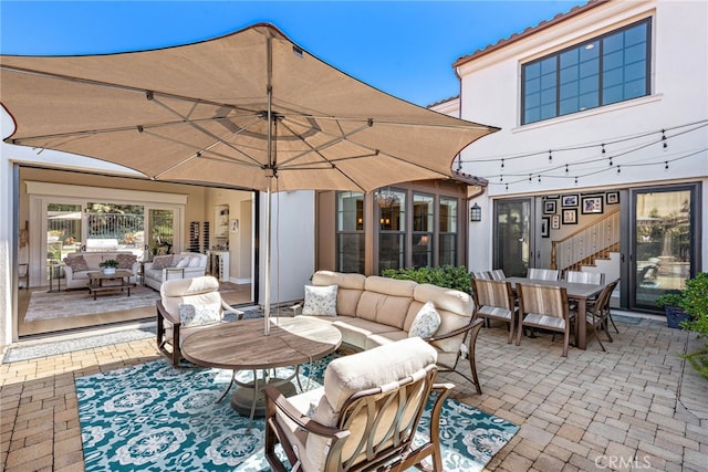 view of patio with outdoor lounge area and outdoor dining area