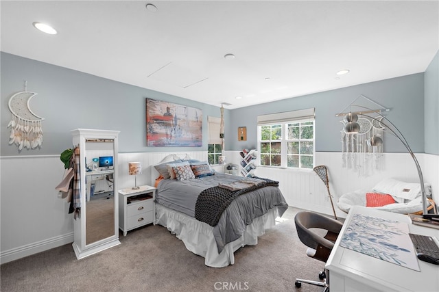 bedroom with carpet floors, recessed lighting, and wainscoting