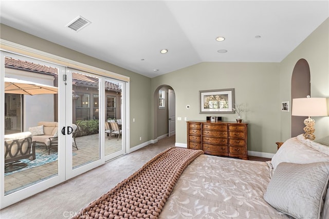 bedroom featuring arched walkways, lofted ceiling, visible vents, baseboards, and access to exterior