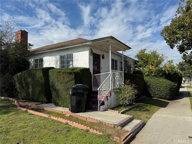 view of side of property featuring stucco siding