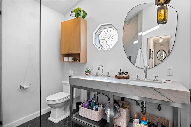 bathroom with baseboards, a sink, and toilet