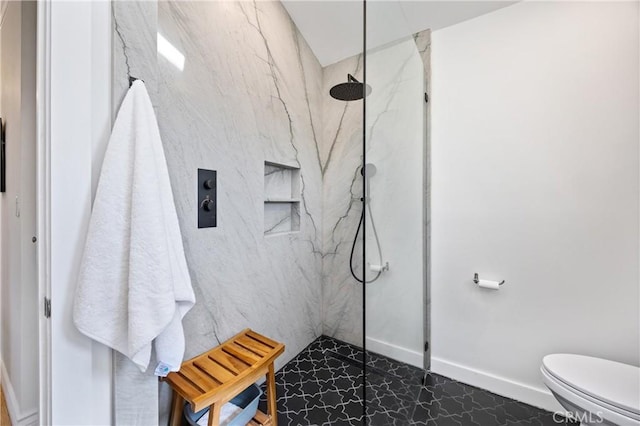 full bath featuring toilet, a marble finish shower, and baseboards