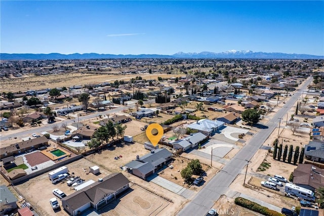 birds eye view of property with a mountain view and a desert view