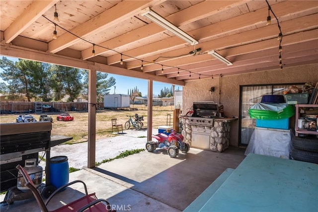 view of patio / terrace with a shed, a fenced backyard, and an outbuilding