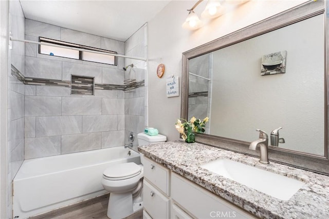 bathroom with vanity, shower / washtub combination, wood finished floors, and toilet