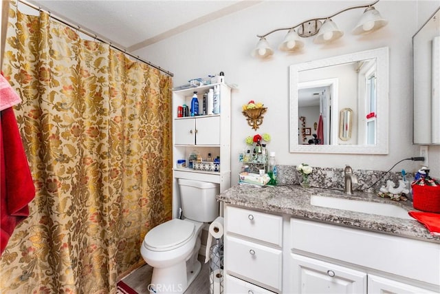 full bath with curtained shower, vanity, and toilet