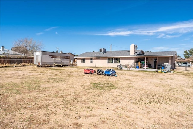 rear view of property with cooling unit, a patio area, and fence