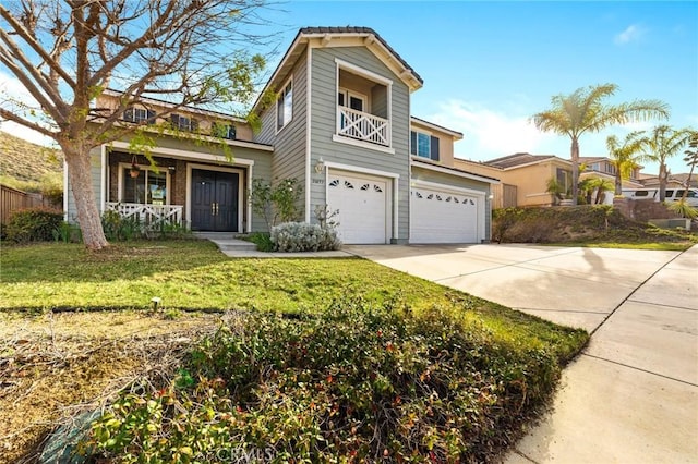 view of front facade featuring a garage, a balcony, a front lawn, and concrete driveway