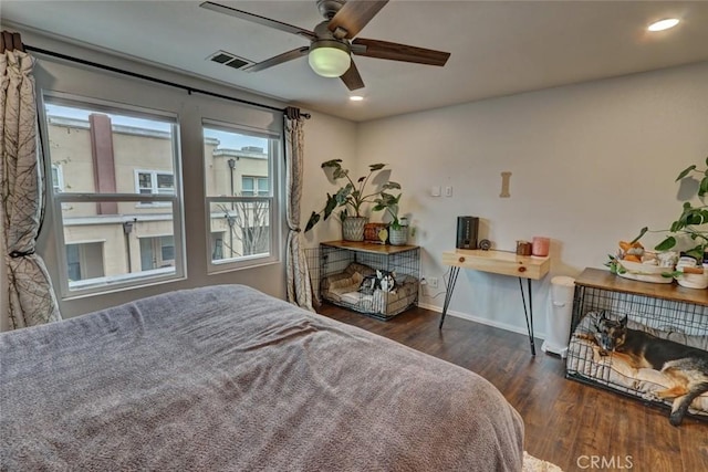 bedroom with baseboards, visible vents, wood finished floors, and recessed lighting