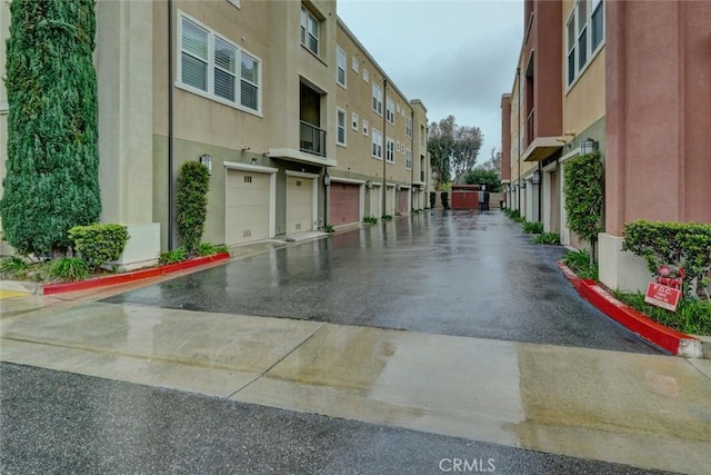 view of street featuring a residential view and curbs