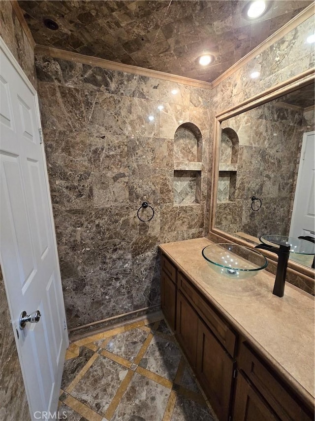 bathroom featuring ornamental molding, recessed lighting, vanity, and tile walls