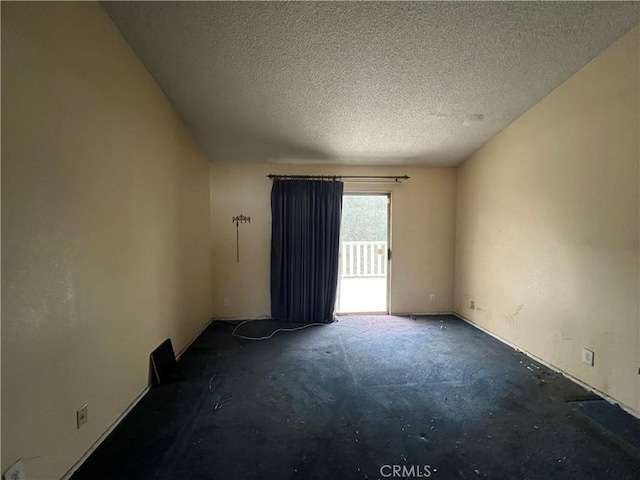 empty room with a textured ceiling