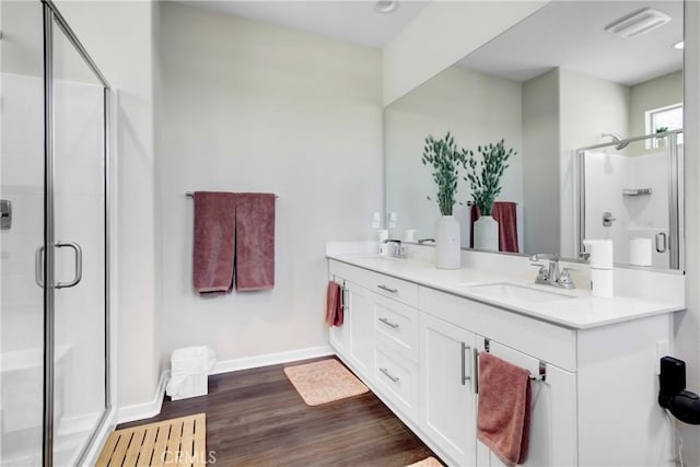 7082 Mallow Dr Unit 4, Fontana, CA 92336 - full bathroom featuring baseboards, a stall shower, double vanity, and wood finished floors