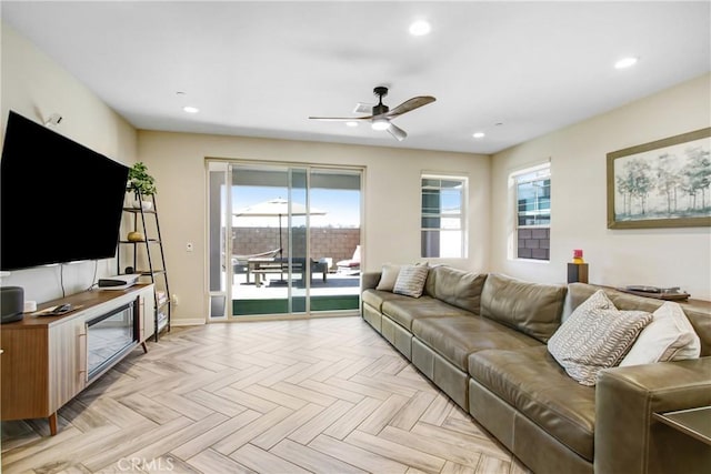 living room with baseboards, plenty of natural light, a ceiling fan, and recessed lighting