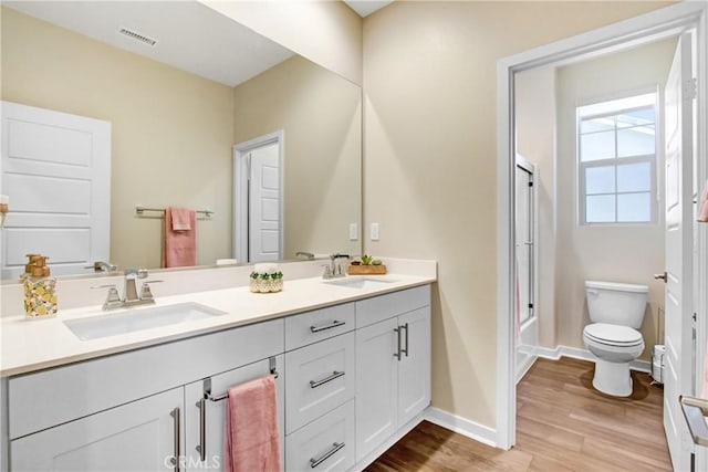 7082 Mallow Dr Unit 4, Fontana, CA 92336 - full bath with toilet, baseboards, double vanity, and wood finished floors
