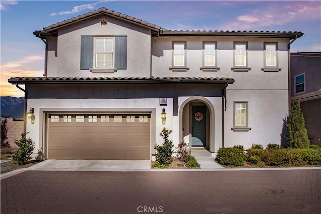 7082 Mallow Dr Unit 4, Fontana, CA 92336 - view of front of house with a garage, stucco siding, decorative driveway, and a tile roof