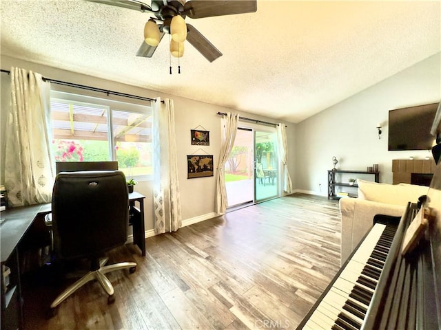 office with vaulted ceiling, ceiling fan, a textured ceiling, and wood finished floors