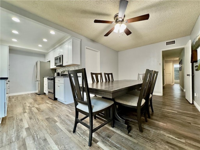 dining area with recessed lighting, baseboards, visible vents, and light wood finished floors