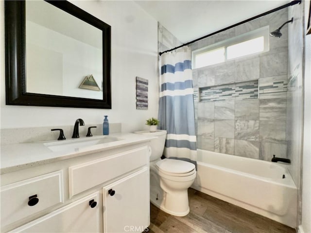 full bath featuring vanity, shower / tub combo, wood finished floors, and toilet