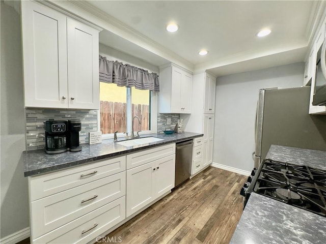 kitchen featuring white cabinets, dark wood-style floors, stainless steel appliances, and a sink