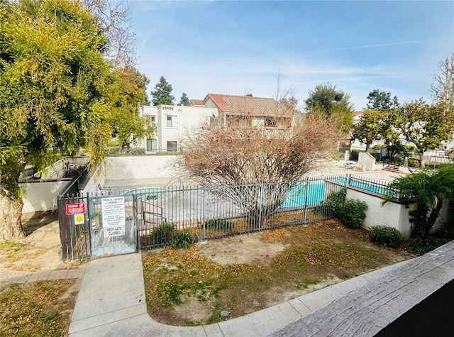 exterior space featuring fence and a community pool