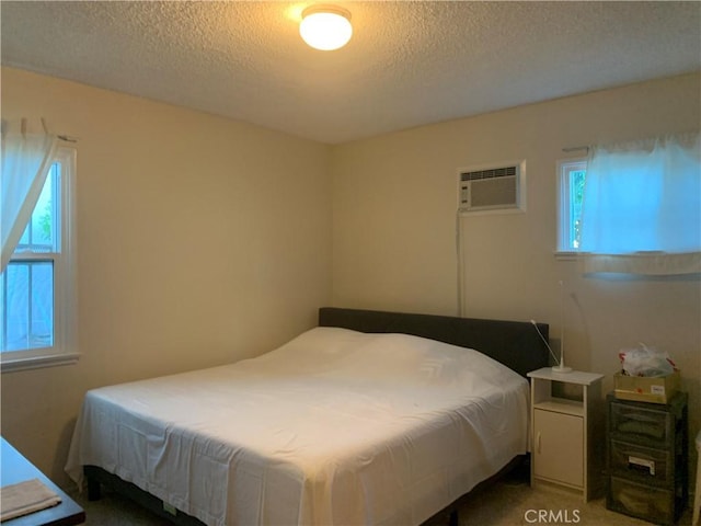 2665 Millet Ave, El Monte, CA 71733 - bedroom featuring an AC wall unit, light carpet, and a textured ceiling