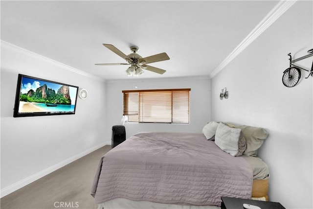 carpeted bedroom featuring baseboards, ceiling fan, and crown molding